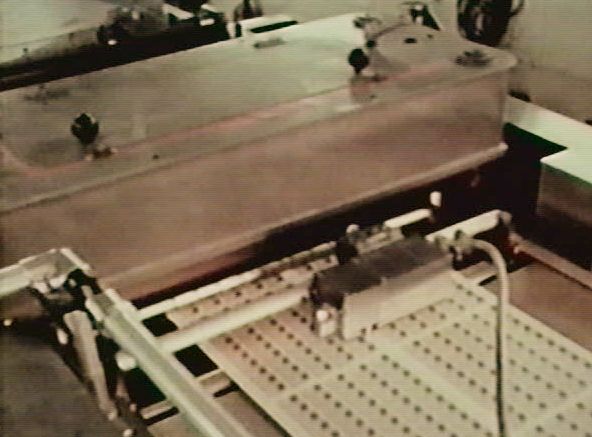 The metal box-like structure
                is the top half of the platen perforator