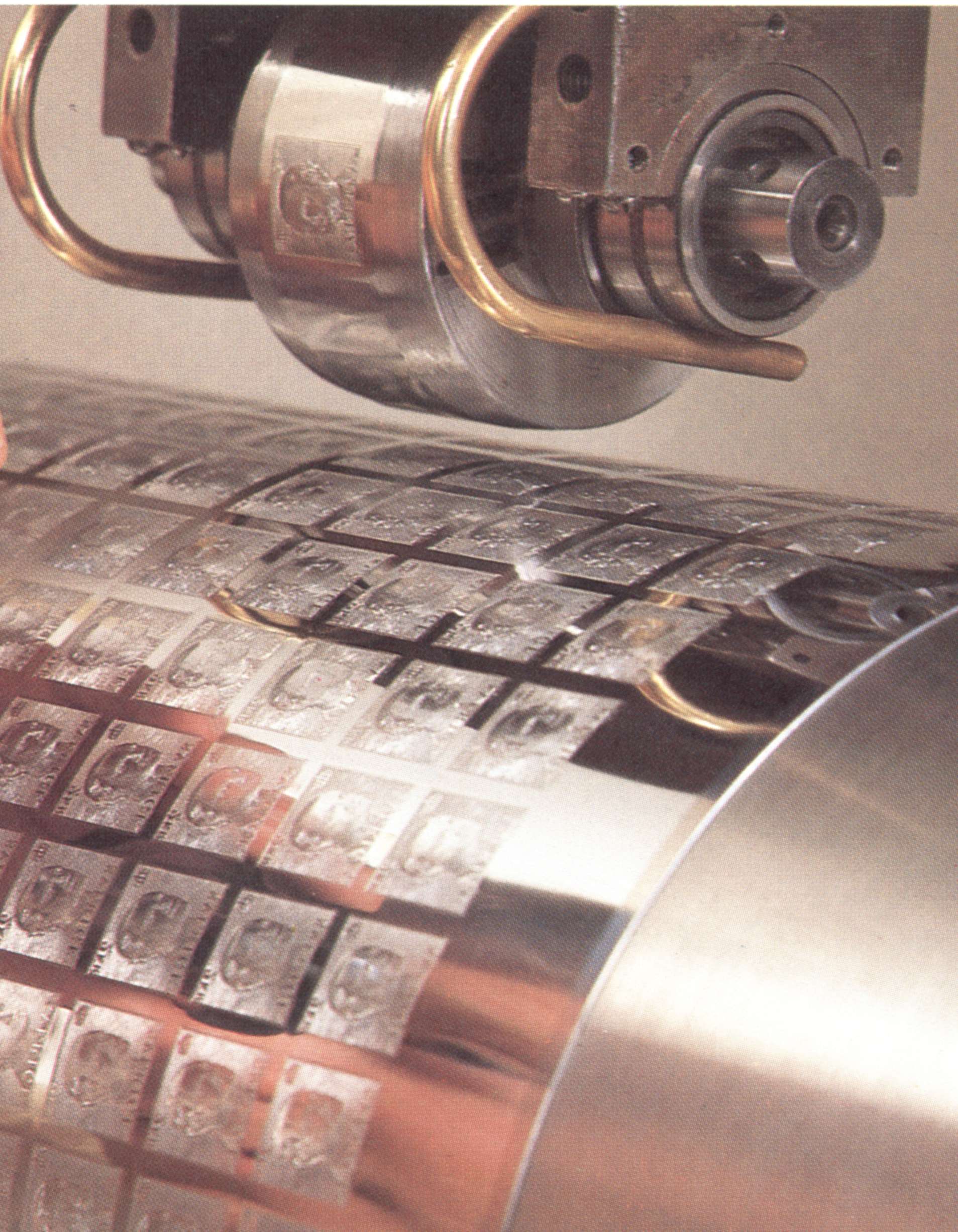 Close-up of the
                        transfer roll mounted in the Rotary Transfer Machine, above the intaglio cylinder