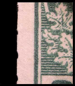 Magnified view of part of the second fake 2 cent green endwise 
        coil showing traces of perforation holes on the left side
