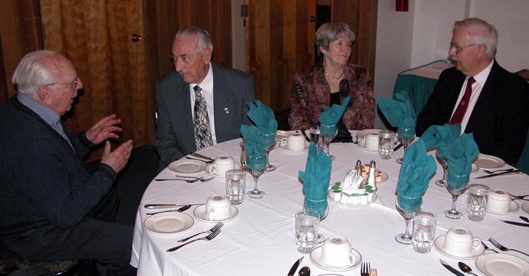 Ed Harris and Cec Coutts
                    have a hearty discussion while June Coutts and Jon Johnson look on